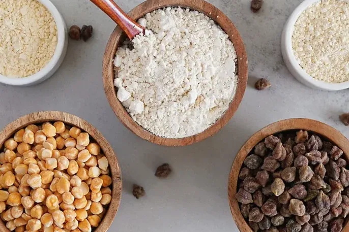 Chickpea flour and seeds in bowls